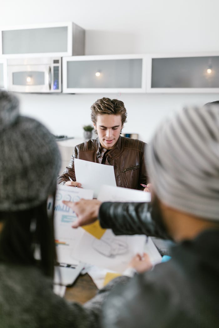A diverse team having a brainstorming session indoors, focused on planning and teamwork.