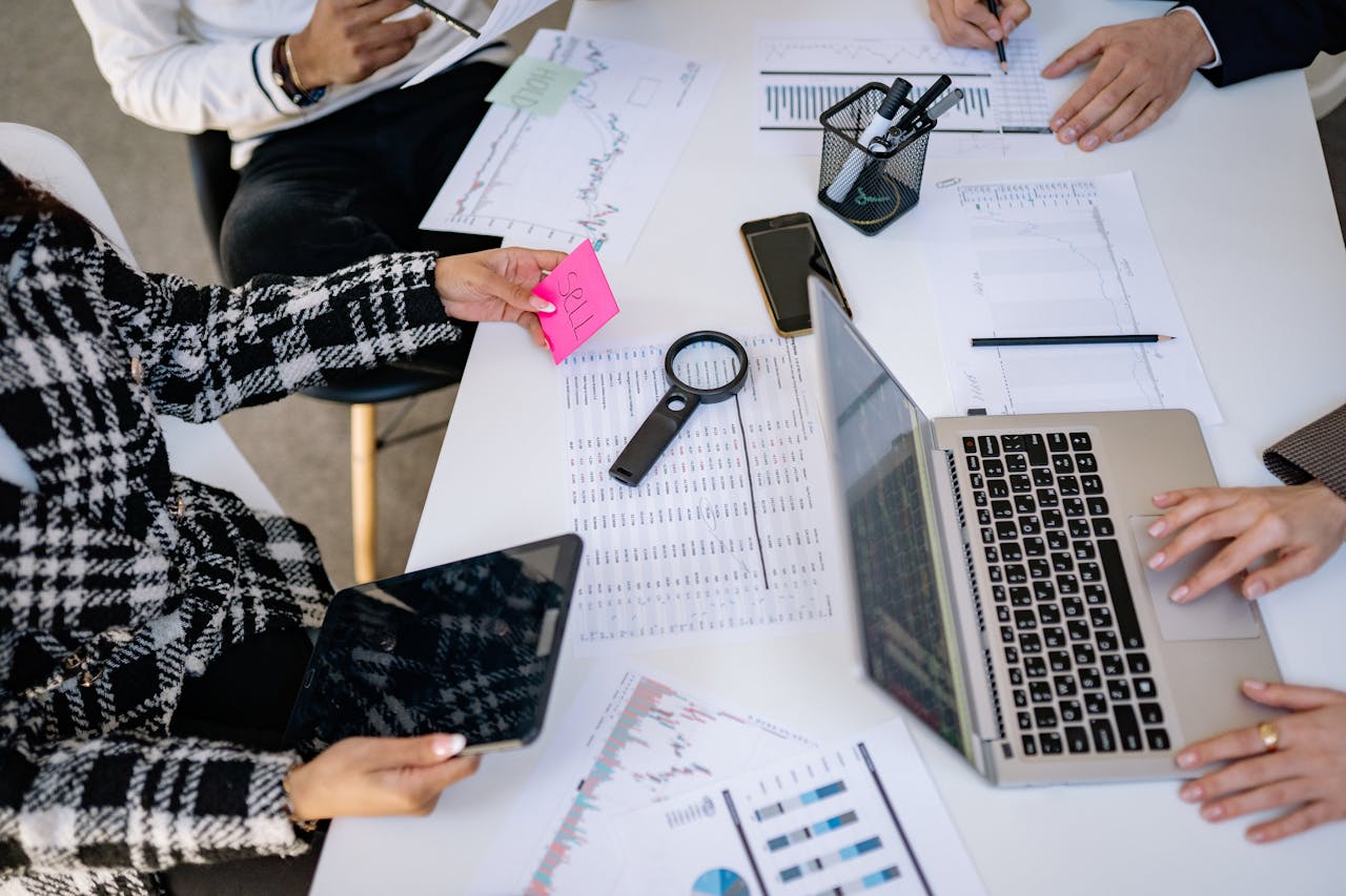 Business professionals collaborating on financial data analysis in a modern office setting.